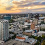 Aerial shot of Sacramento's skyline during a picturesque sunset with vibrant clouds.
